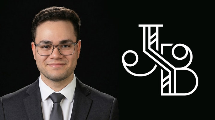 Javin Balla Headshot and logo, Javin is facing the camera, dressed in a suit, 